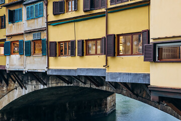 The Ponte Vecchio, a medieval stone closed-spandrel segmental arch bridge over the Arno, in...