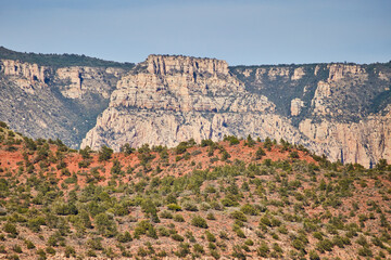 Sedona Cliffs with Red-Orange Terrain and Green Shrubs