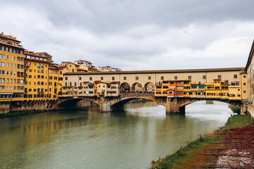 Obraz premium The Ponte Vecchio, a medieval stone closed-spandrel segmental arch bridge over the Arno, in Florence, Italy