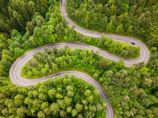 Aerial view of a road in the middle of the forest