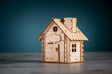 Small wooden decorative house on table, studio background