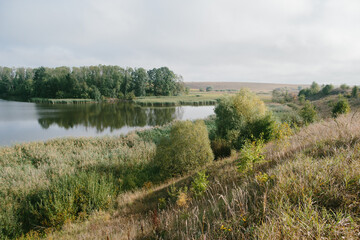 A picturesque landscape with a pond near the village.