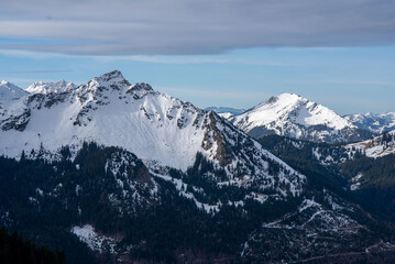 Panorama of a snow covered mountain lake. Winter mountain snow lake. Lake in snowy mountains. Mountain lake in snow