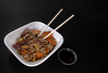 Freshly made Chinese fried rice with meat and vegetables, with space for text