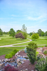 Naklejka premium Morning Serenity at Golf Course with Landscaped Garden and Pond