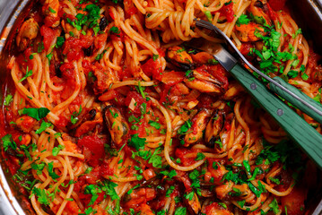 Spaghetti with tomato sauce and mussels.top view