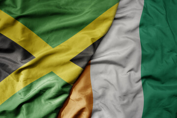 big waving national colorful flag of cote divoire and national flag of jamaica .