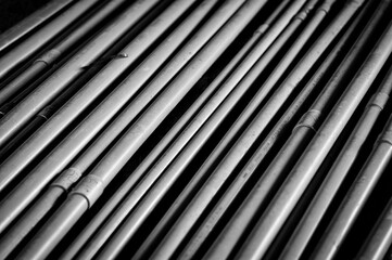 Obraz premium A close up image of gray conduits in a stack. Good background for electrical, construction or industry. 