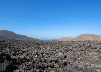 The volcanic mountain landscape of Lanzarote, Spain, under a clear sky