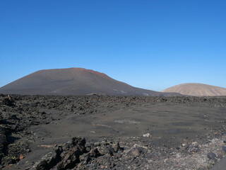 The volcanic mountain landscape of Lanzarote, Spain, under a clear sky