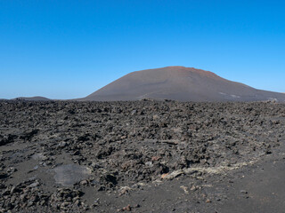 The volcanic mountain landscape of Lanzarote, Spain, under a clear sky
