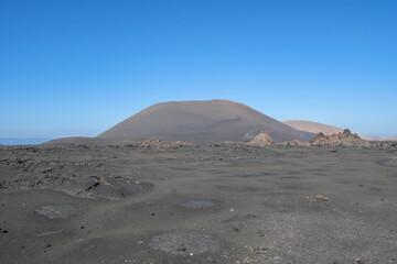 The volcanic mountain landscape of Lanzarote, Spain, under a clear sky