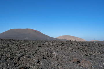 The volcanic mountain landscape of Lanzarote, Spain, under a clear sky