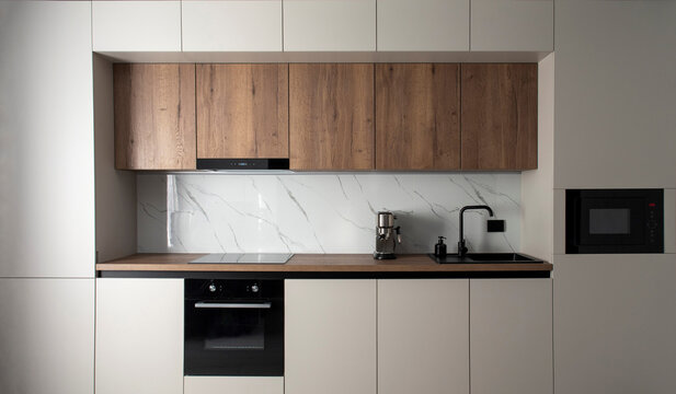 Modern built-in kitchen with appliances in a minimalist style