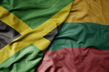 big waving national colorful flag of lithuania and national flag of jamaica .