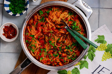 Spaghetti with tomato sauce and mussels.top view