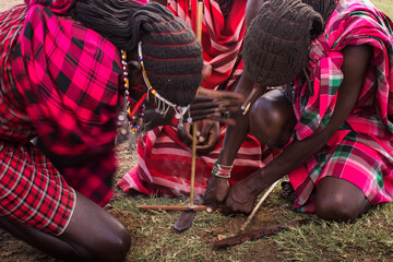 Maasai People making fire in traditional way, Kenya