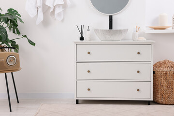 Different bath accessories and personal care products in stylish bathroom