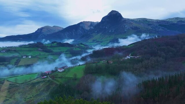 Aerial drone view of the winter landscape around the town of Gainza and Amezqueta and the Txindoki Mountain. Aralar Mountain Range. Goierri region. Gipuzkoa. Basque Country. Spain. Europe