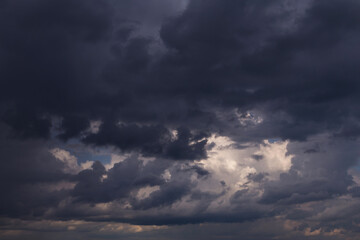 Epic Dramatic Storm sky with dark grey and black cumulus rainy clouds background texture, thunderstorm