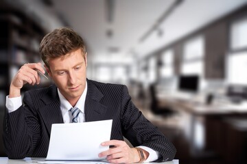 Business man with documents writing signatures for legal paperwork