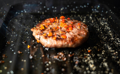 Succulent hamburger on a homemade grill, tempting smoke, irresistible aroma, prepared with love and dedication.
