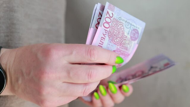 Female hands holding paper bills Belarusian rubles 