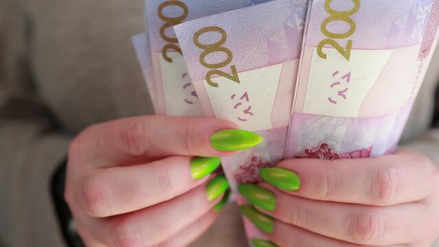 Female hands holding paper bills Belarusian rubles 