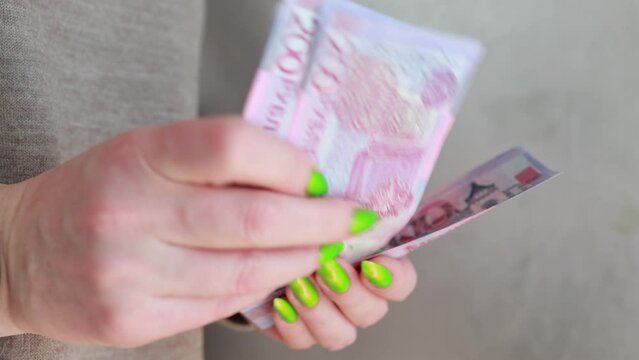 Female hands holding paper bills Belarusian rubles 