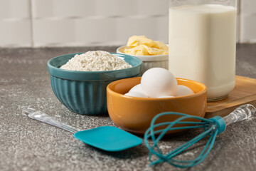 Ingredients to prepare cake. Wheat flour, eggs, butter and milk.