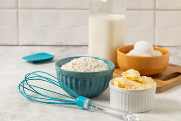 Ingredients to prepare cake. Wheat flour, eggs, butter and milk.