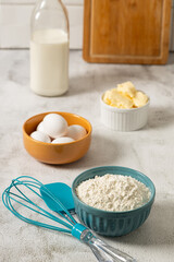 Ingredients to prepare cake. Wheat flour, eggs, butter and milk.