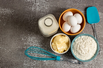 Ingredients to prepare cake. Wheat flour, eggs, butter and milk.