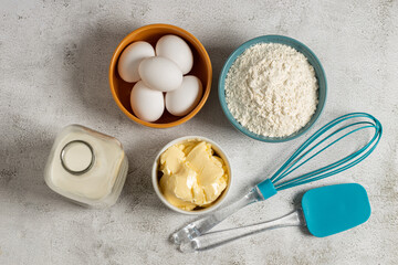 Ingredients to prepare cake. Wheat flour, eggs, butter and milk.