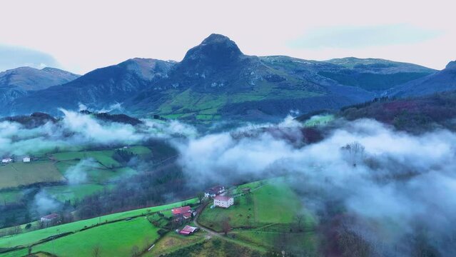 Aerial drone view of the winter landscape around the town of Gainza and Amezqueta and the Txindoki Mountain. Aralar Mountain Range. Goierri region. Gipuzkoa. Basque Country. Spain. Europe