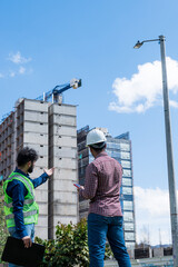 Workers at work looking some documents for a deal in construction site