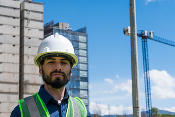 Construction worker man portrait in construction site in sunny day