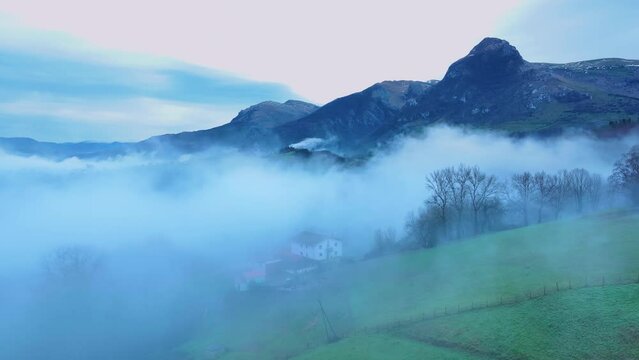 Aerial drone view of the winter landscape around the town of Gainza and Amezqueta and the Txindoki Mountain. Aralar Mountain Range. Goierri region. Gipuzkoa. Basque Country. Spain. Europe