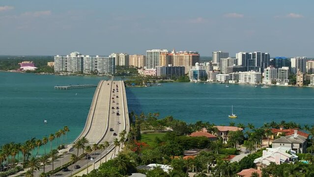 USA travel destination. Aerial view of Sarasota city downtown with Ringling Bridge and high-rise office buildings on horizon. Real estate development in Florida