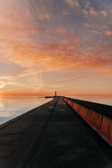Fototapeta na wymiar sunset in the sea and a long jetty