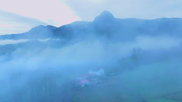 Aerial drone view of the winter landscape around the town of Gainza and Amezqueta and the Txindoki Mountain. Aralar Mountain Range. Goierri region. Gipuzkoa. Basque Country. Spain. Europe