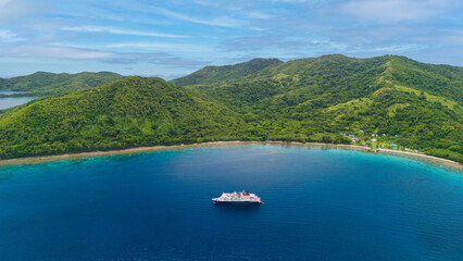 Luxury cruise ship visiting tropical destination 