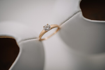 Valmiera, Latvia - July 7, 2023 - Close-up of an engagement ring with a diamond, placed on the edge...