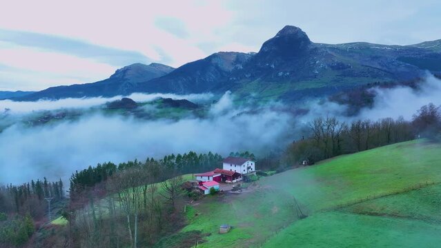 Aerial drone view of the winter landscape around the town of Gainza and Amezqueta and the Txindoki Mountain. Aralar Mountain Range. Goierri region. Gipuzkoa. Basque Country. Spain. Europe