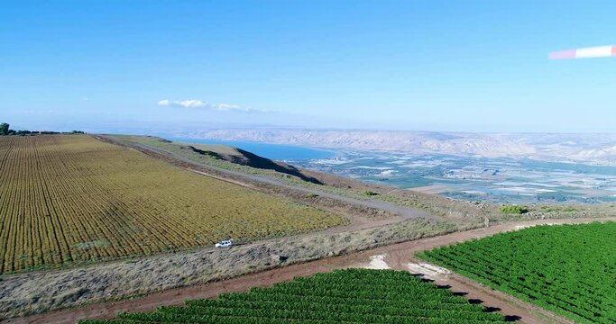 Aerial footage of a wind turbine in the mountains above the Sea of Galilee.