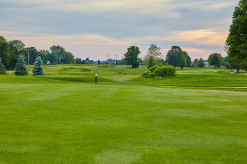 Fototapeta na wymiar Golden Hour Serenity at Pine Valley Golf Course, Lush Fairways View