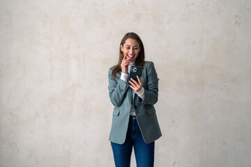 Business woman, studio and smartphone for reading notification, mobile chat and social network. Happy female scroll on cellphone, news app and search digital information on grey background.