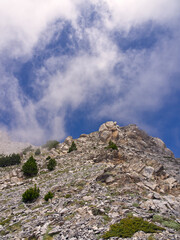 Mountain rocky hillside with blue cloud sky. High quality photo