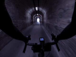 Motion blur riding a bicycle inside a tunnel rider chest point of view