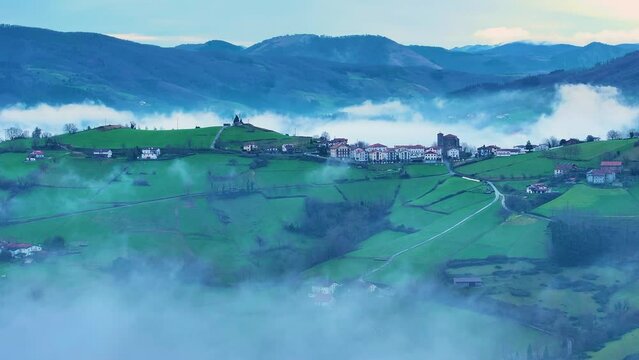 Aerial drone view of the winter landscape around the town of Gainza and Amezqueta and the Txindoki Mountain. Aralar Mountain Range. Goierri region. Gipuzkoa. Basque Country. Spain. Europe